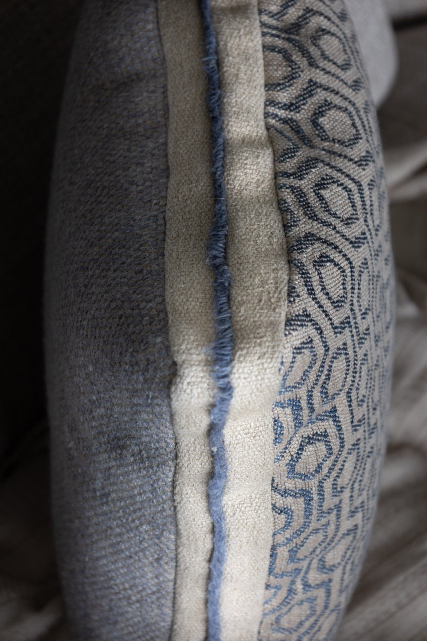 Martin Gabriel leinen kissen auf Sofa seitenasicht mit geometrischen Muster sichtbar hinten und vorne , uni blau und front mit geometriemuster 